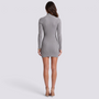 Essyro grey ribbed knit mini dress with high neck and long sleeves, back view on a model wearing nude heels.