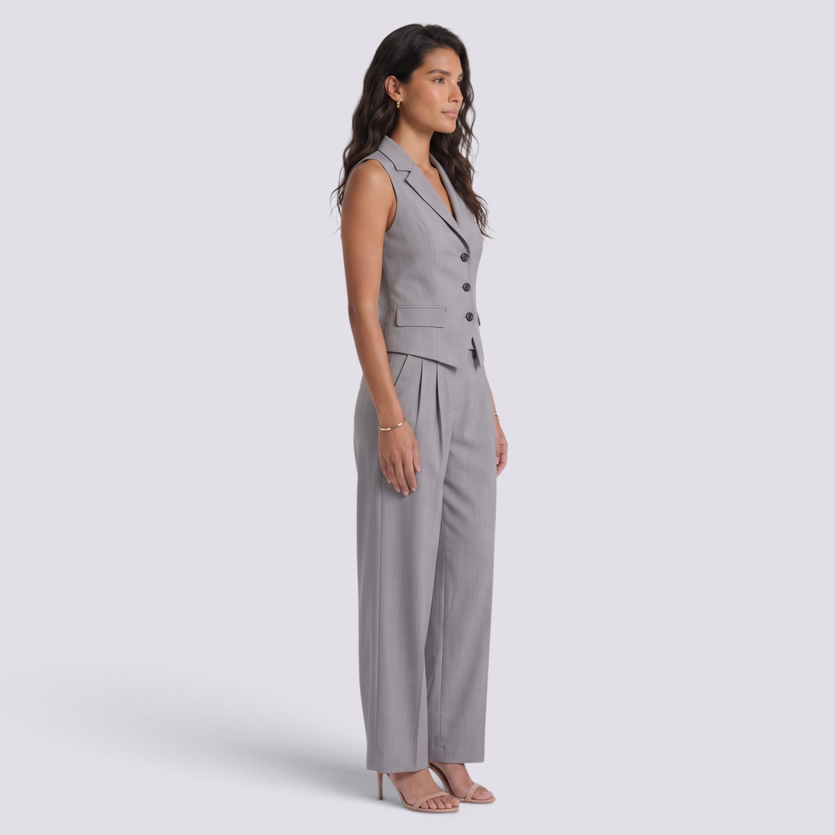 Essyro grey tailored two-piece set featuring a sleeveless vest and matching trousers on a model in profile view