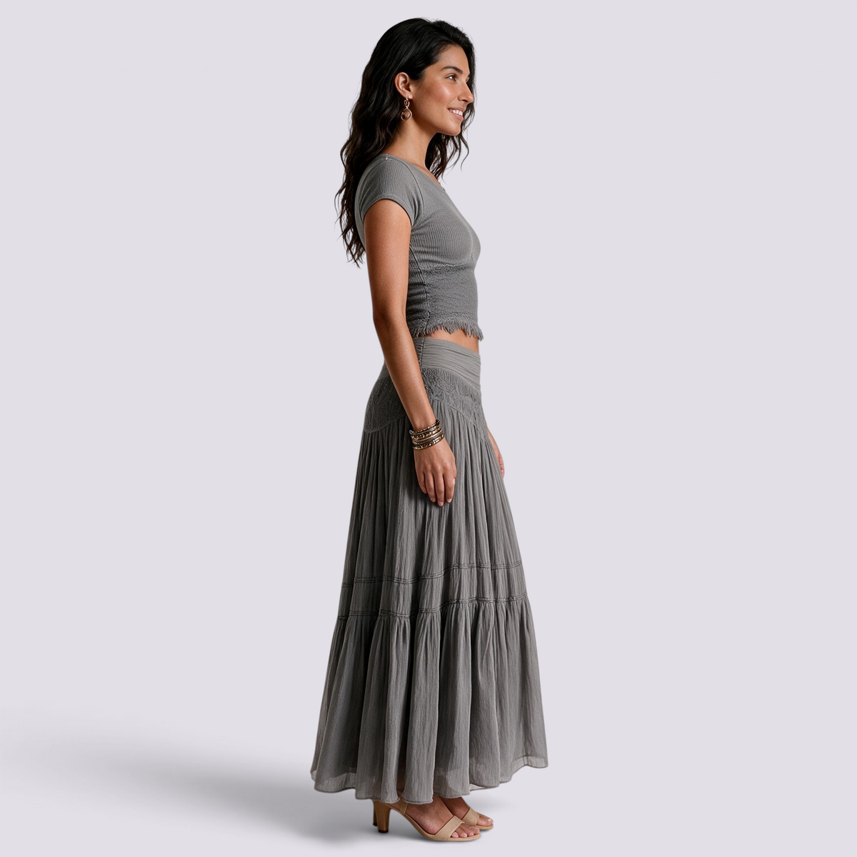 Essyro two-piece set featuring a grey fitted short-sleeve top and a flowing maxi skirt with textured waist detail.