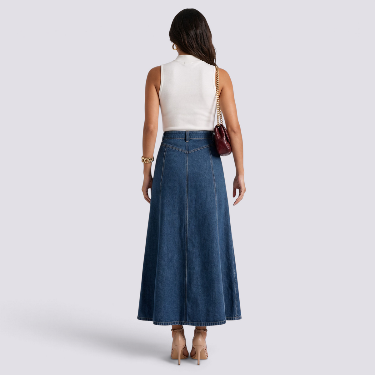 Essyro high-waisted maxi denim skirt with vertical panels and flared silhouette, back view on a model.