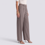 Essyro high-waisted wide-leg trousers in taupe with a fluid drape and tailored fit, worn with strappy heels.