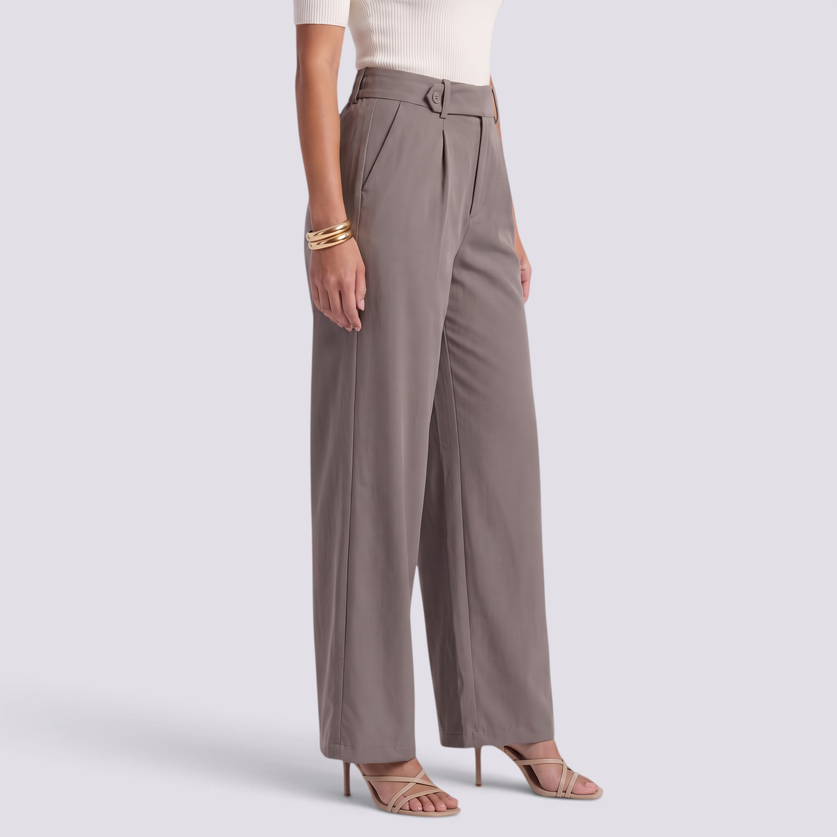 Essyro high-waisted wide-leg trousers in taupe with a fluid drape and tailored fit, worn with strappy heels.