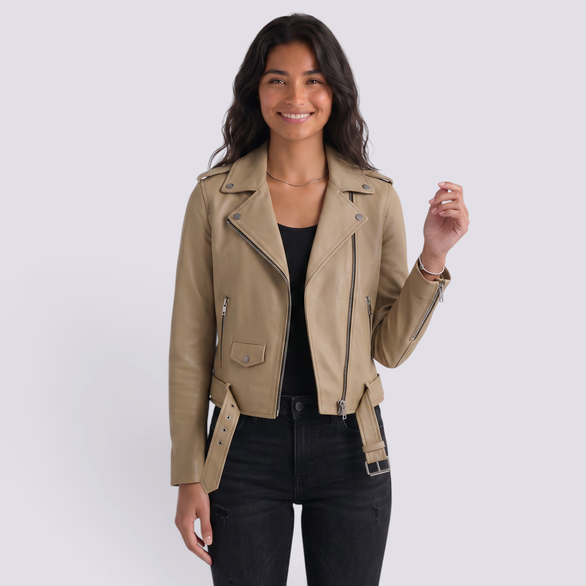Essyro khaki faux leather biker jacket with silver zippers and belted waist worn by a smiling woman
