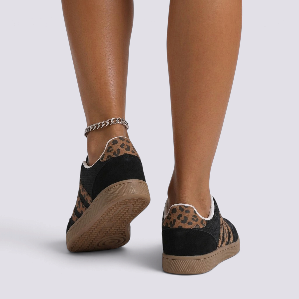 Essyro retro low-top sneakers in black with leopard print suede details and a flat gum rubber sole, rear view.
