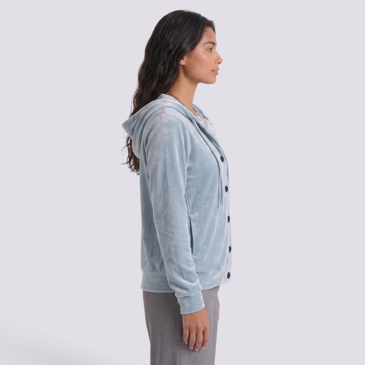 Essyro light blue velvet hooded cardigan with front buttons and pockets worn by a model in a side profile view