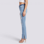 Essyro light wash high-waisted flared jeans with side slits and distressed knee rips worn by a model in heels