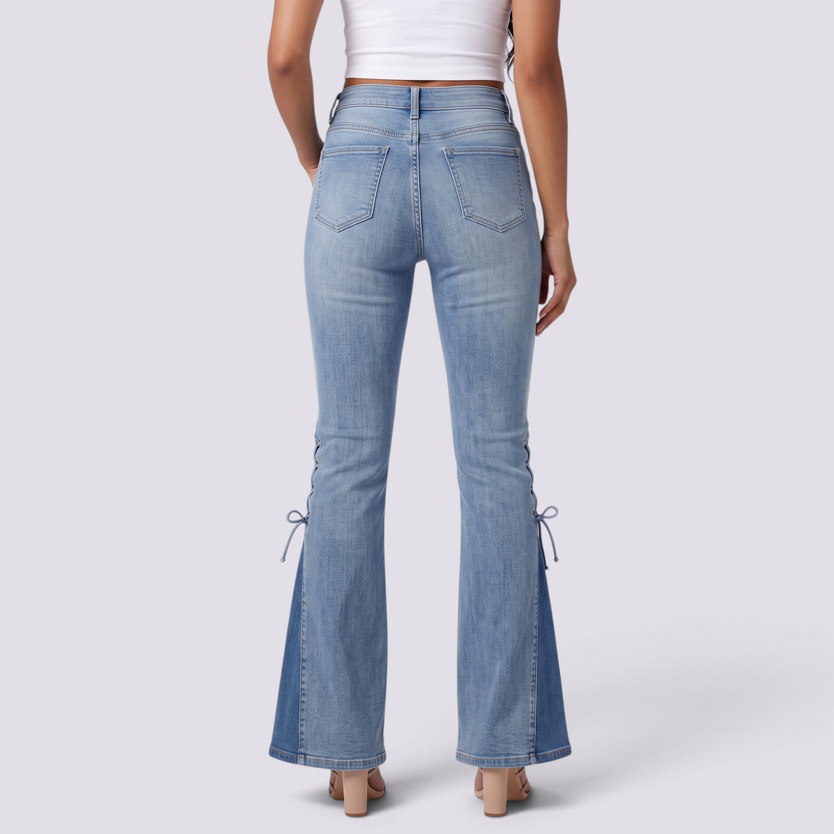 Essyro women's light wash flared jeans with side lace-up details and godet hem, back view on a model