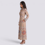 Essyro long beige dress with V-neck, long sleeves, and geometric print, worn by a model in a studio setting.