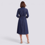 Back view of a woman wearing an Essyro long denim shirt dress with a waist belt and flared skirt in dark blue denim.