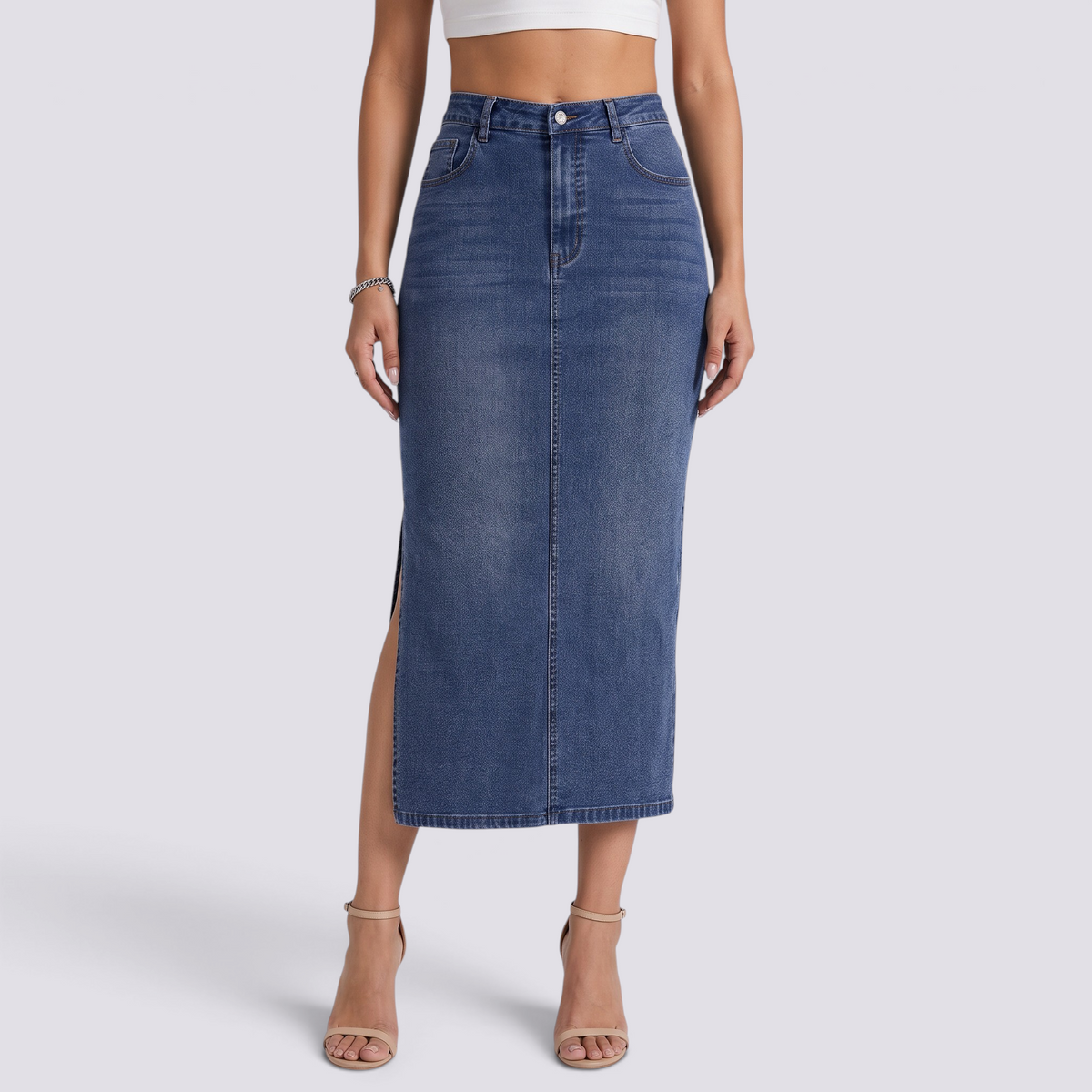 Essyro long fitted denim skirt in vintage wash blue with a side slit worn by a model with beige heels