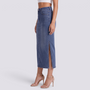 Essyro long fitted denim skirt in vintage blue wash with a side slit, worn by a model with beige high heels.