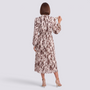 Essyro long-sleeve midi dress with brown and cream abstract print, pleated skirt, and high neck, back view.