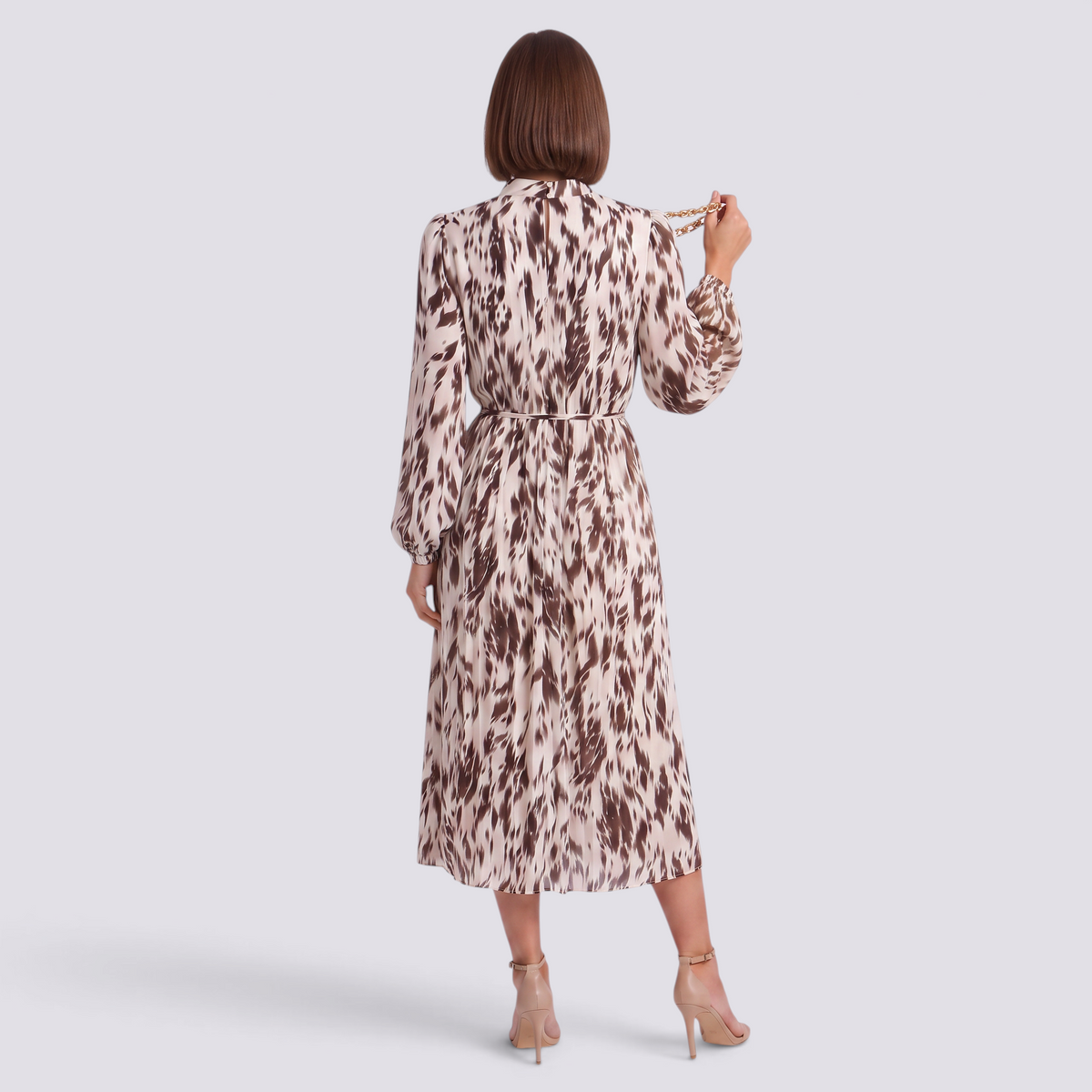 Essyro long-sleeve midi dress with brown and cream abstract print, pleated skirt, and high neck, back view.