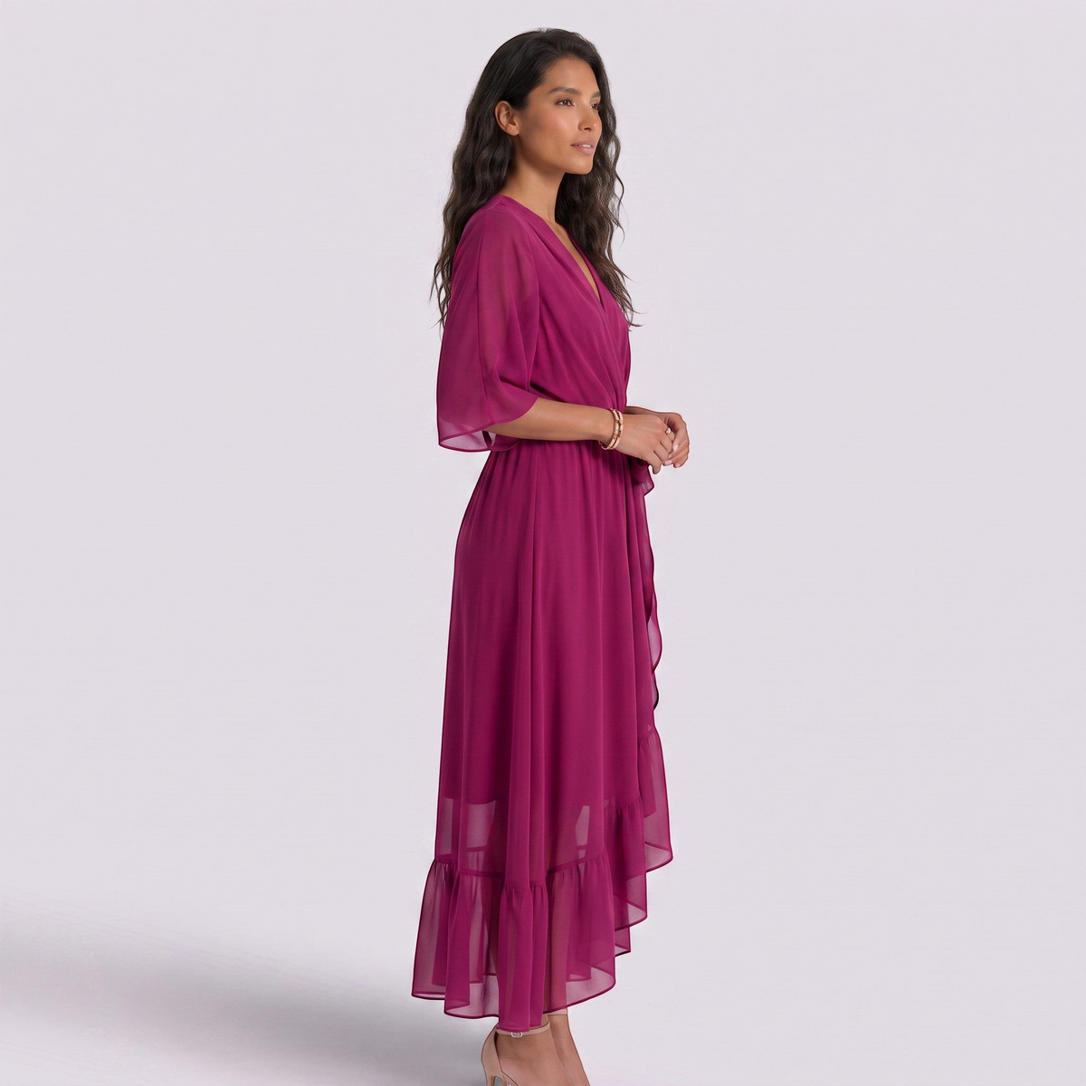 Essyro magenta maxi dress with V-neck, batwing sleeves, and an asymmetrical ruffled hem on a model