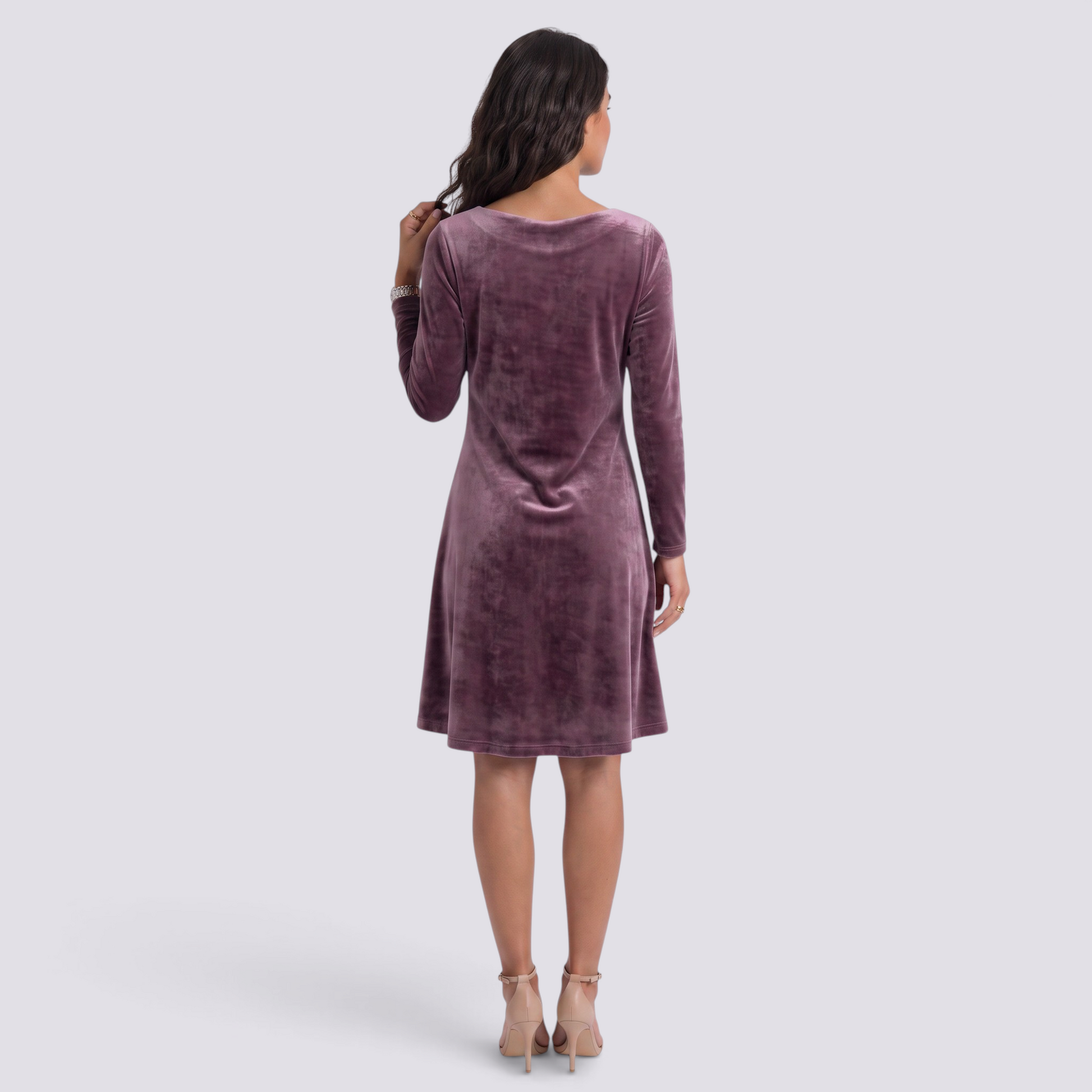 Back view of a woman wearing an Essyro mauve velvet short dress with long sleeves and a flattering flared cut.