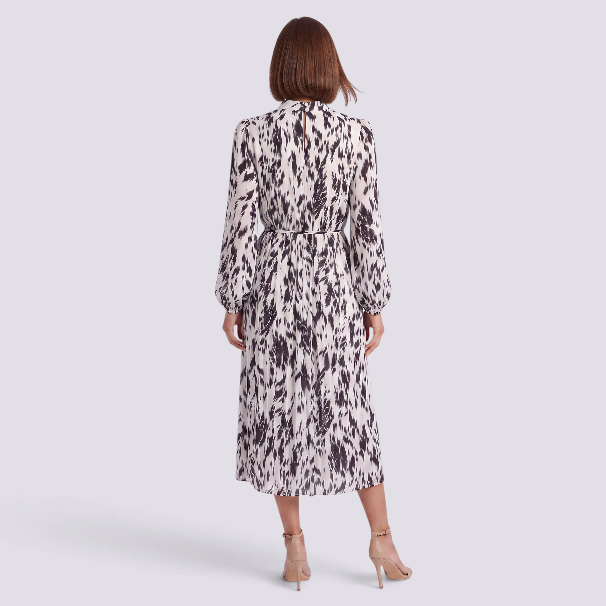 Back view of an Essyro midi dress with long sleeves, high neck, and a black and white abstract print on pleated fabric.