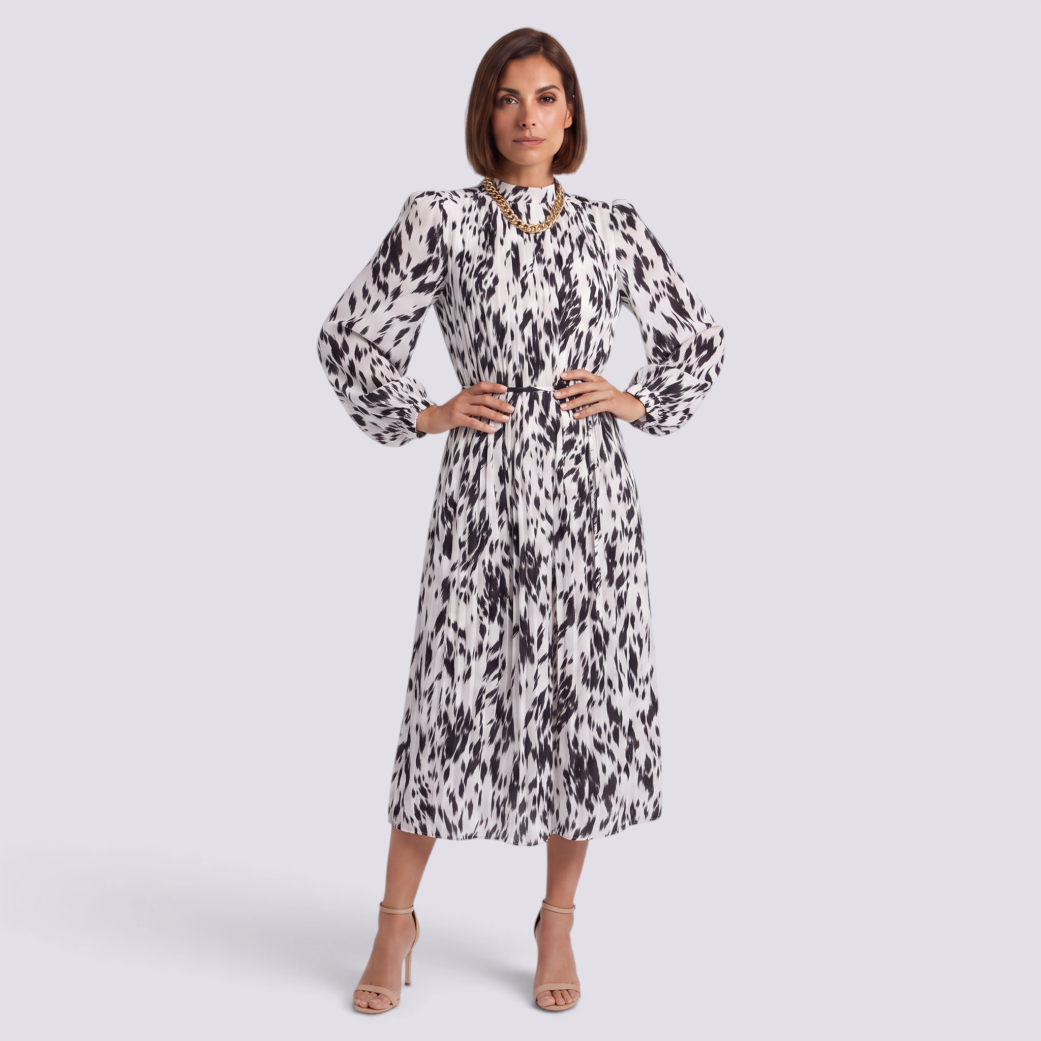 Essyro midi dress with black and white abstract print, high neck, long sleeves, and pleated skirt on a model.