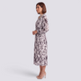 Essyro midi dress with long sleeves, high neck, and abstract print, worn by a woman in profile view.