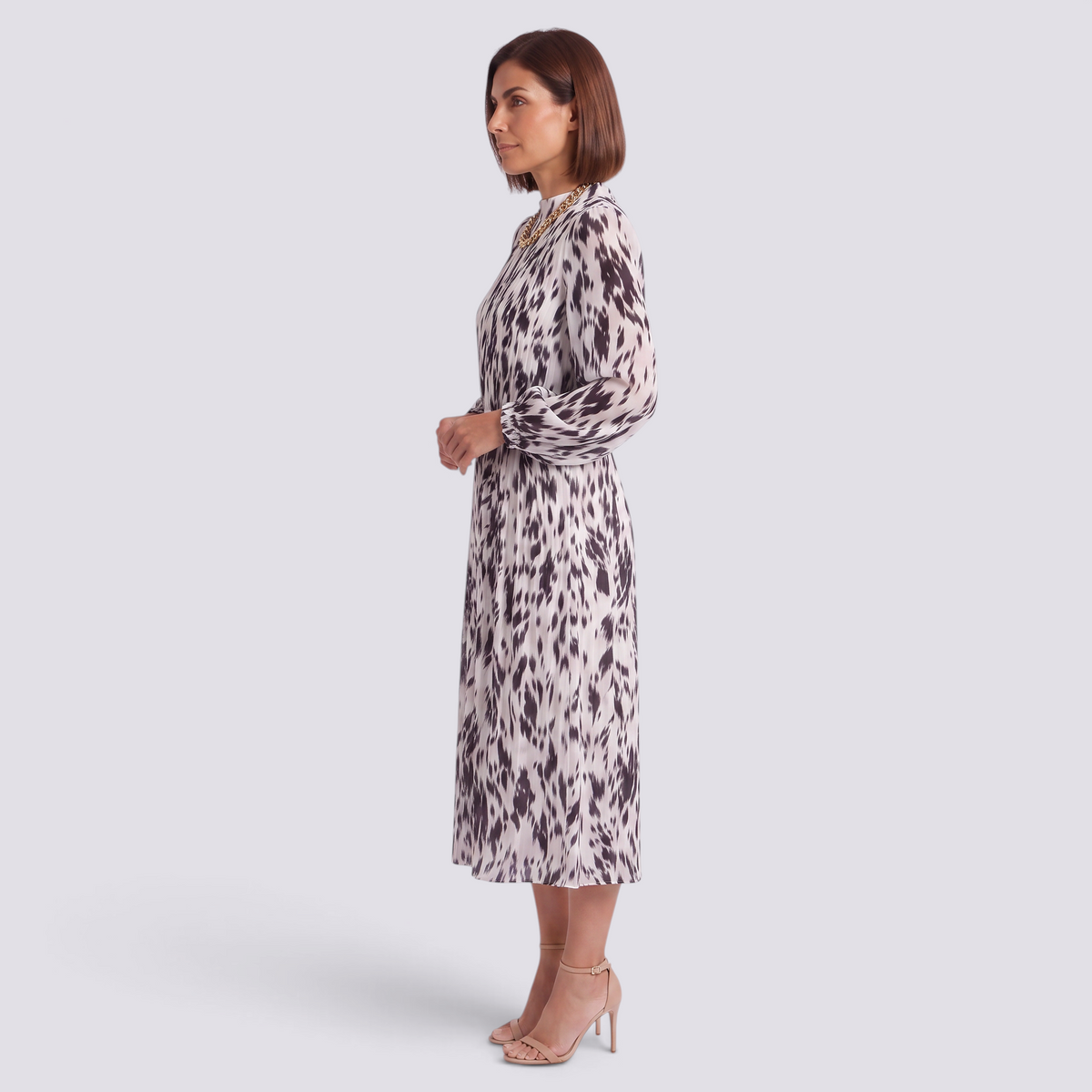 Essyro midi dress with long sleeves, high neck, and abstract print, worn by a woman in profile view.
