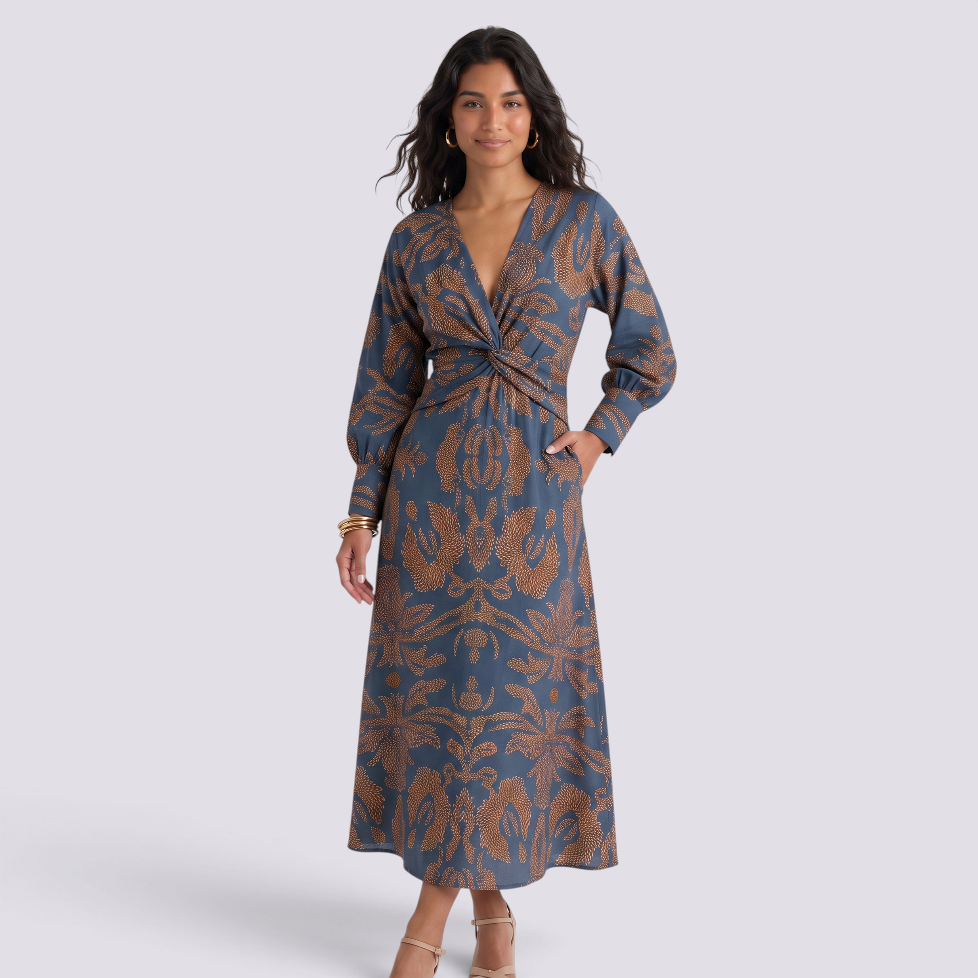 Essyro midi dress with V-neck, 3/4 sleeves, and a blue and brown artistic print on a model against a grey background.