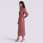 Essyro midi dress with V-neck, 3/4 sleeves, and artistic orange and purple print worn by a model in profile view.
