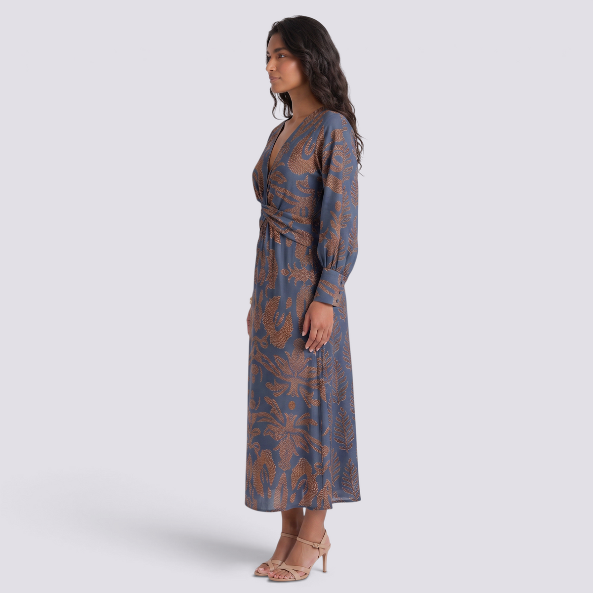 Essyro midi dress with V-neck, 3/4 sleeves, and artistic brown and blue fluid print on a model, side view