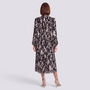 Back view of an Essyro midi dress with long sleeves, high neck, and a black and white abstract print on pleated fabric.