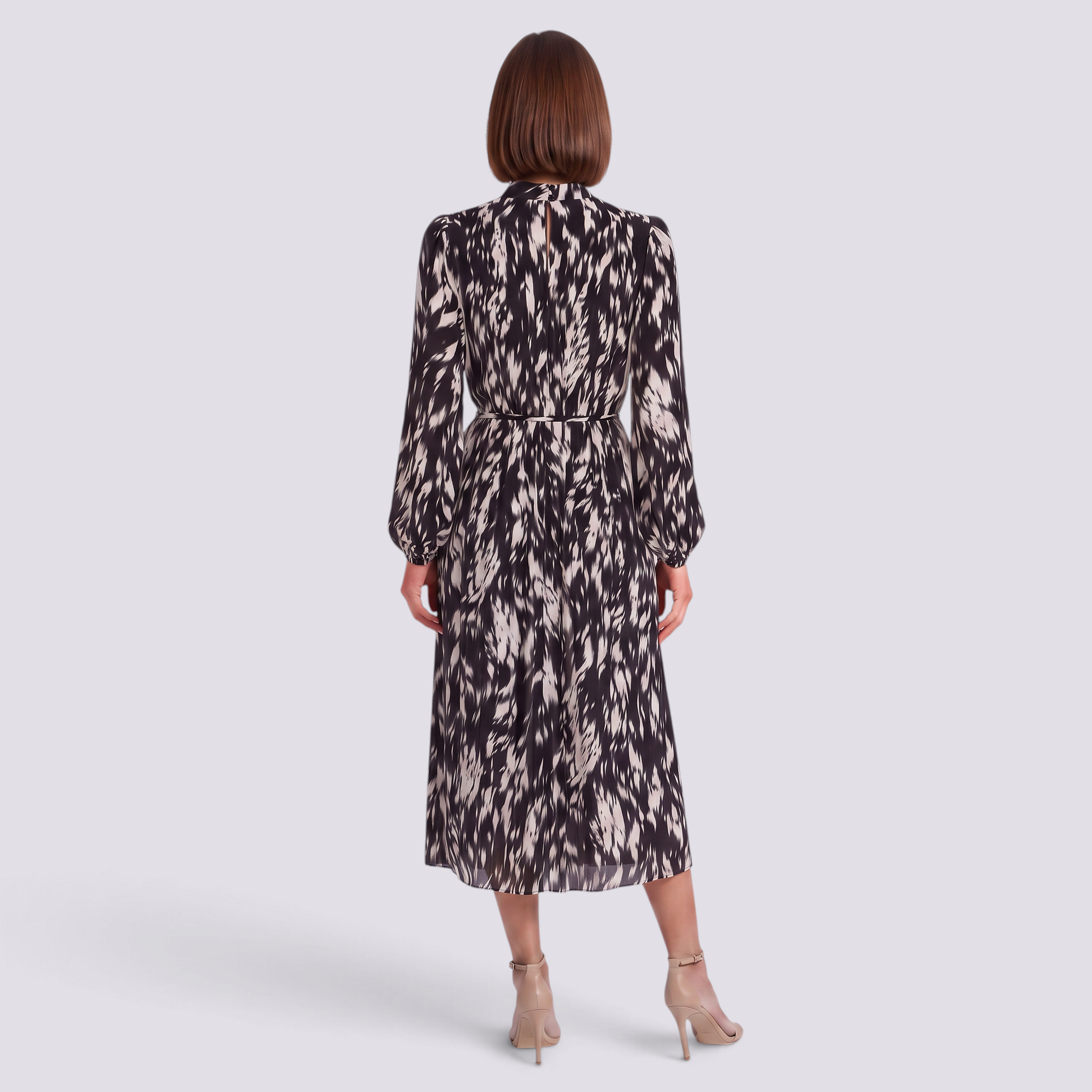 Back view of an Essyro midi dress with long sleeves, high neck, and a black and white abstract print on pleated fabric.
