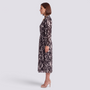 Essyro midi dress with long sleeves, high neck, and abstract print, worn by a woman in profile view.