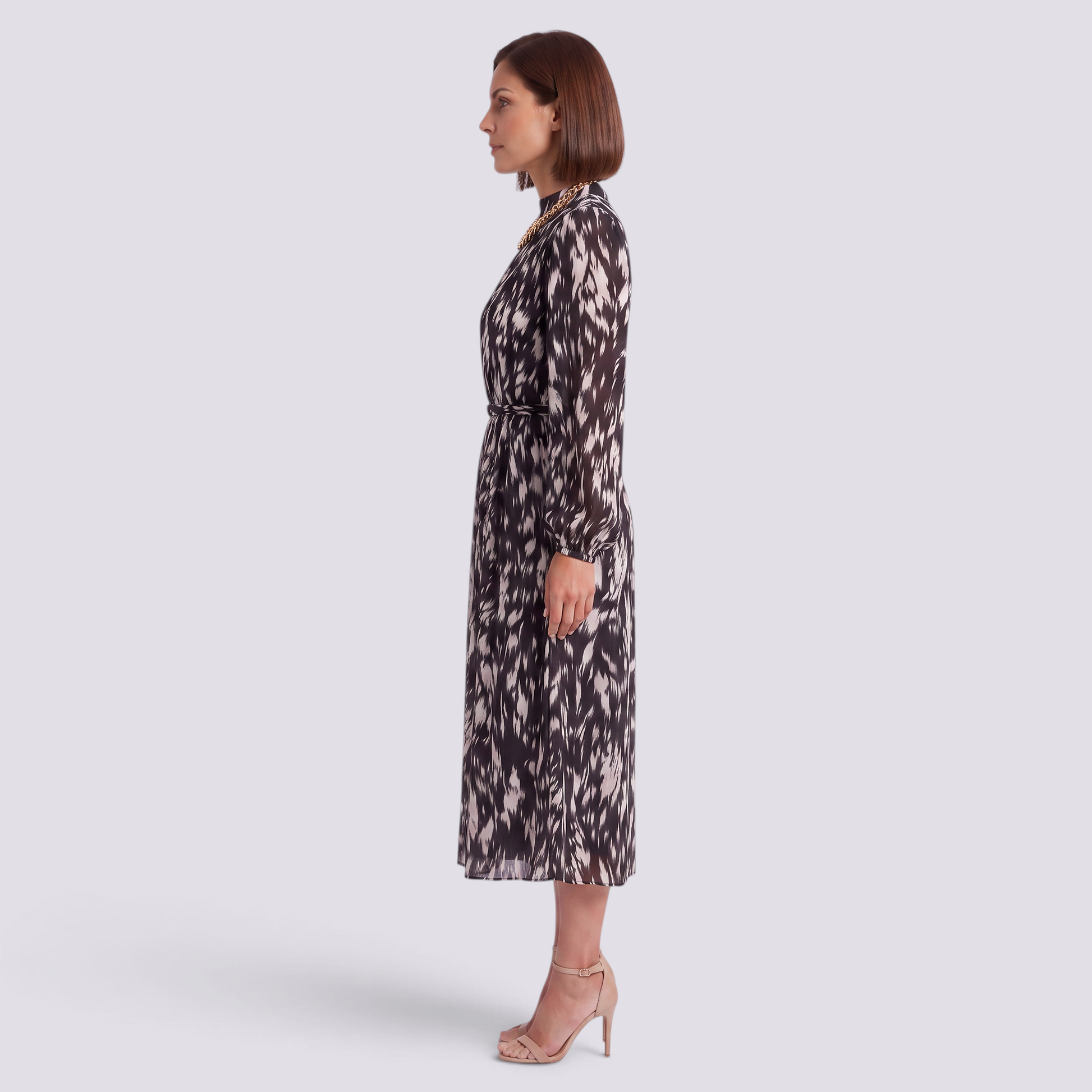 Essyro midi dress with long sleeves, high neck, and abstract print, worn by a woman in profile view.