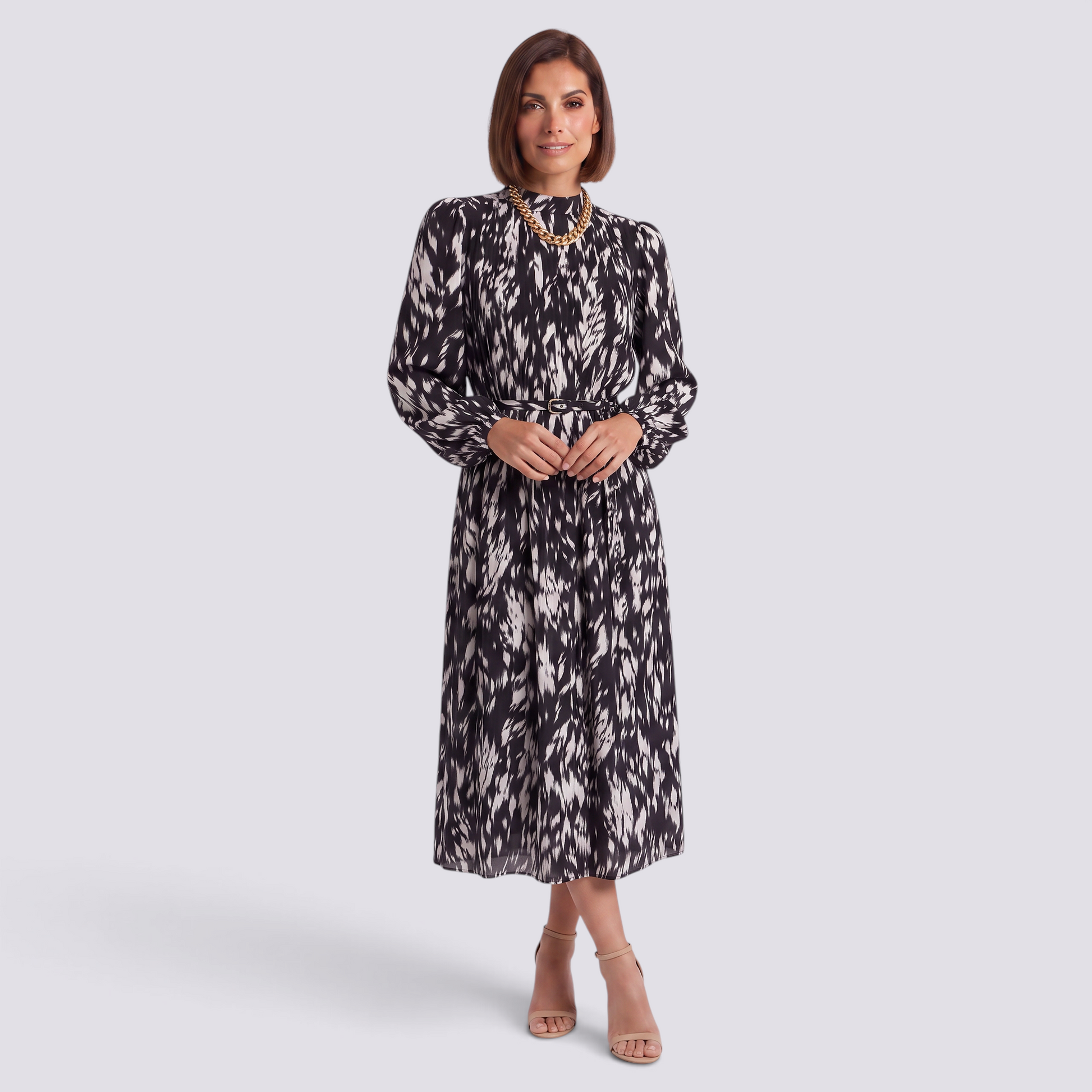 Essyro midi dress with long sleeves, high neck, and black and white abstract print, featuring a pleated skirt.