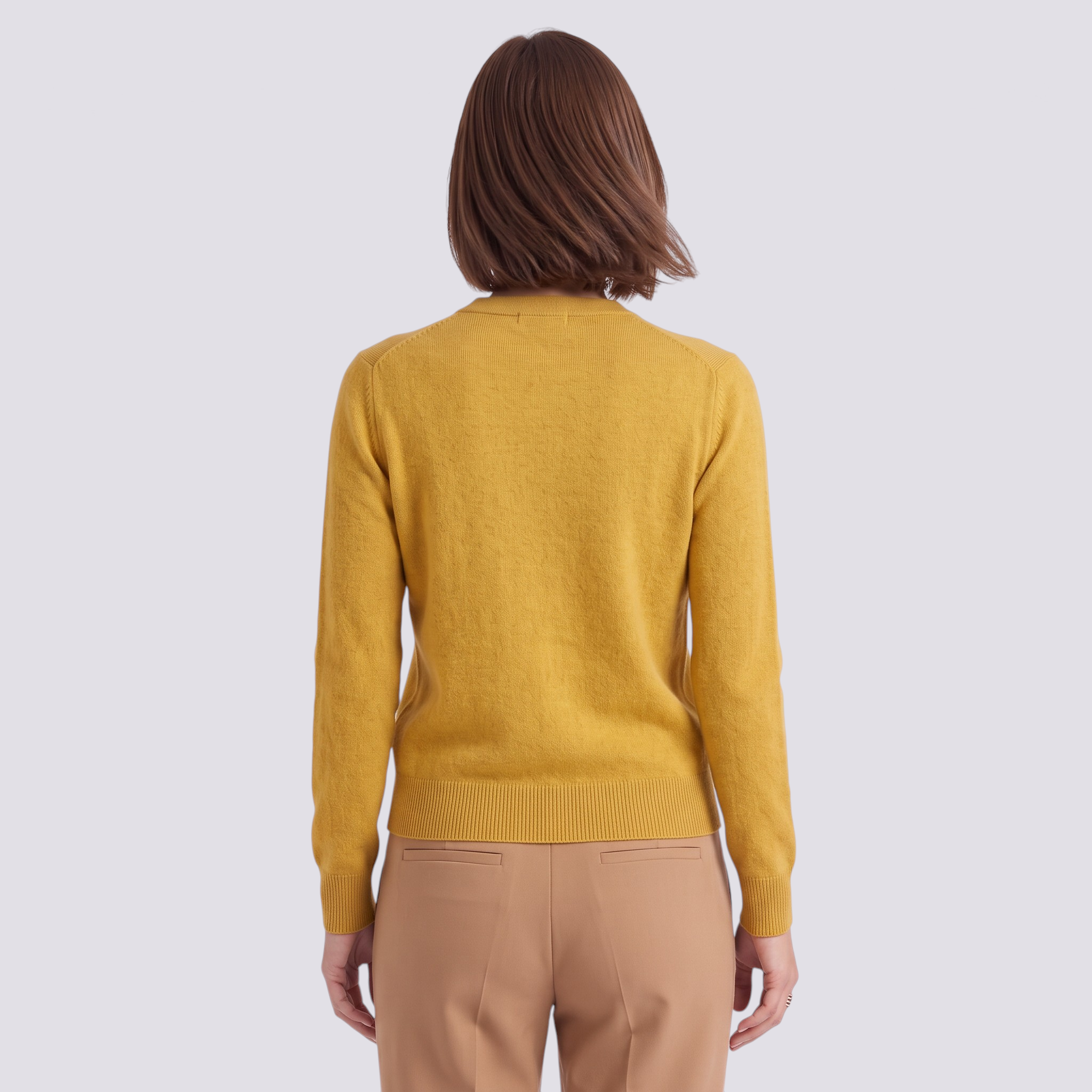 Back view of a woman wearing an Essyro mustard yellow long-sleeve knit cardigan with ribbed cuffs and round neck.