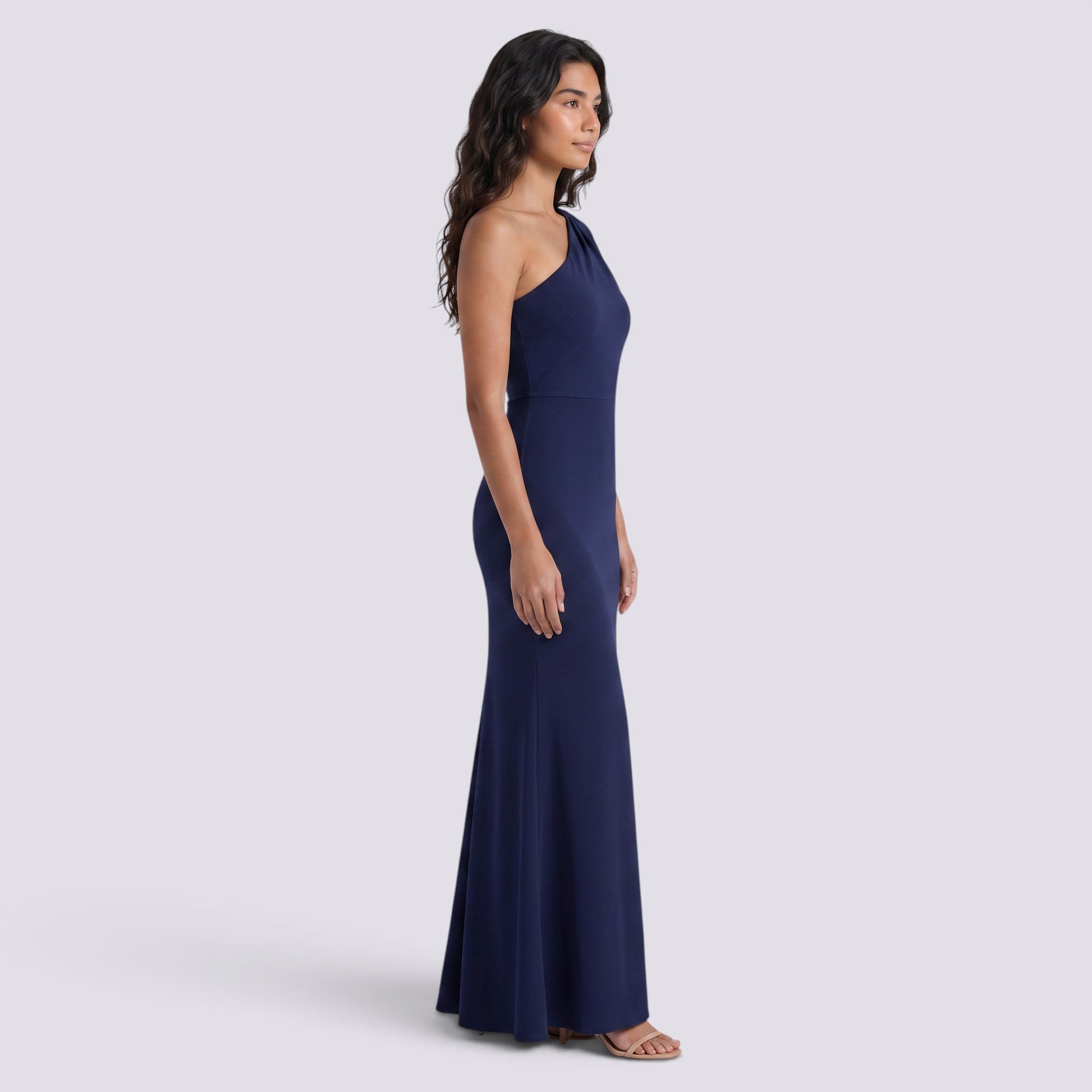 Essyro navy blue floor-length mermaid gown with an asymmetrical one-shoulder neckline worn by a model