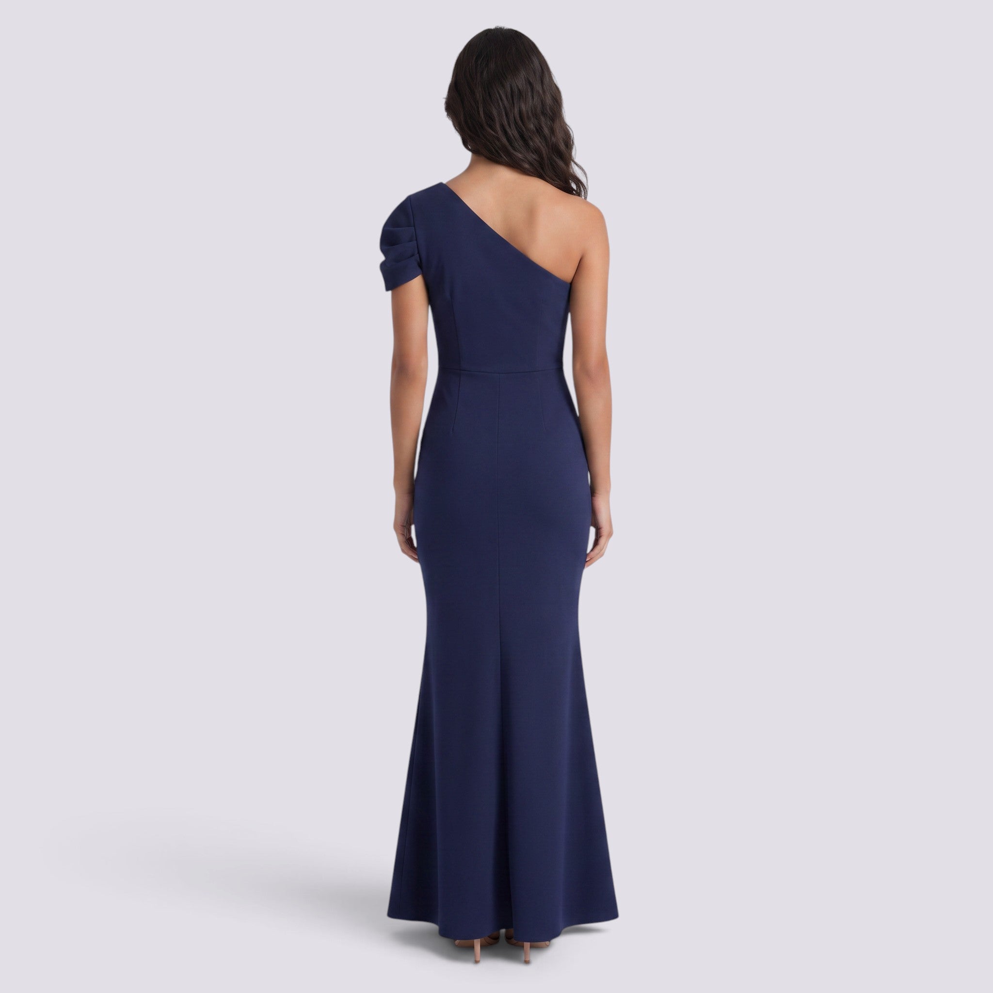 Essyro navy blue floor-length mermaid evening gown with an asymmetrical one-shoulder design and draped sleeve.