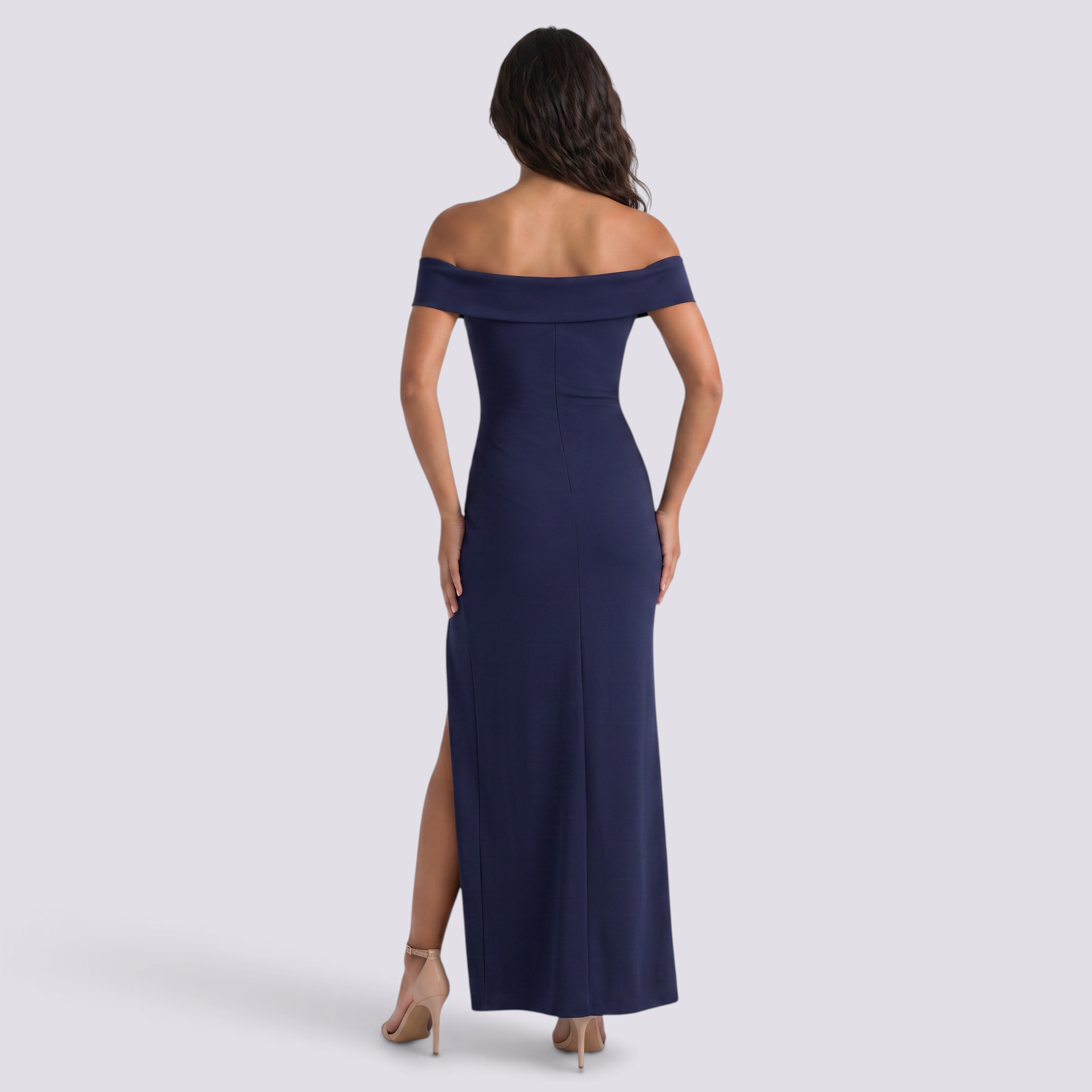 Essyro navy blue bodycon maxi dress with bardot neckline and side slit worn by a model from the back view