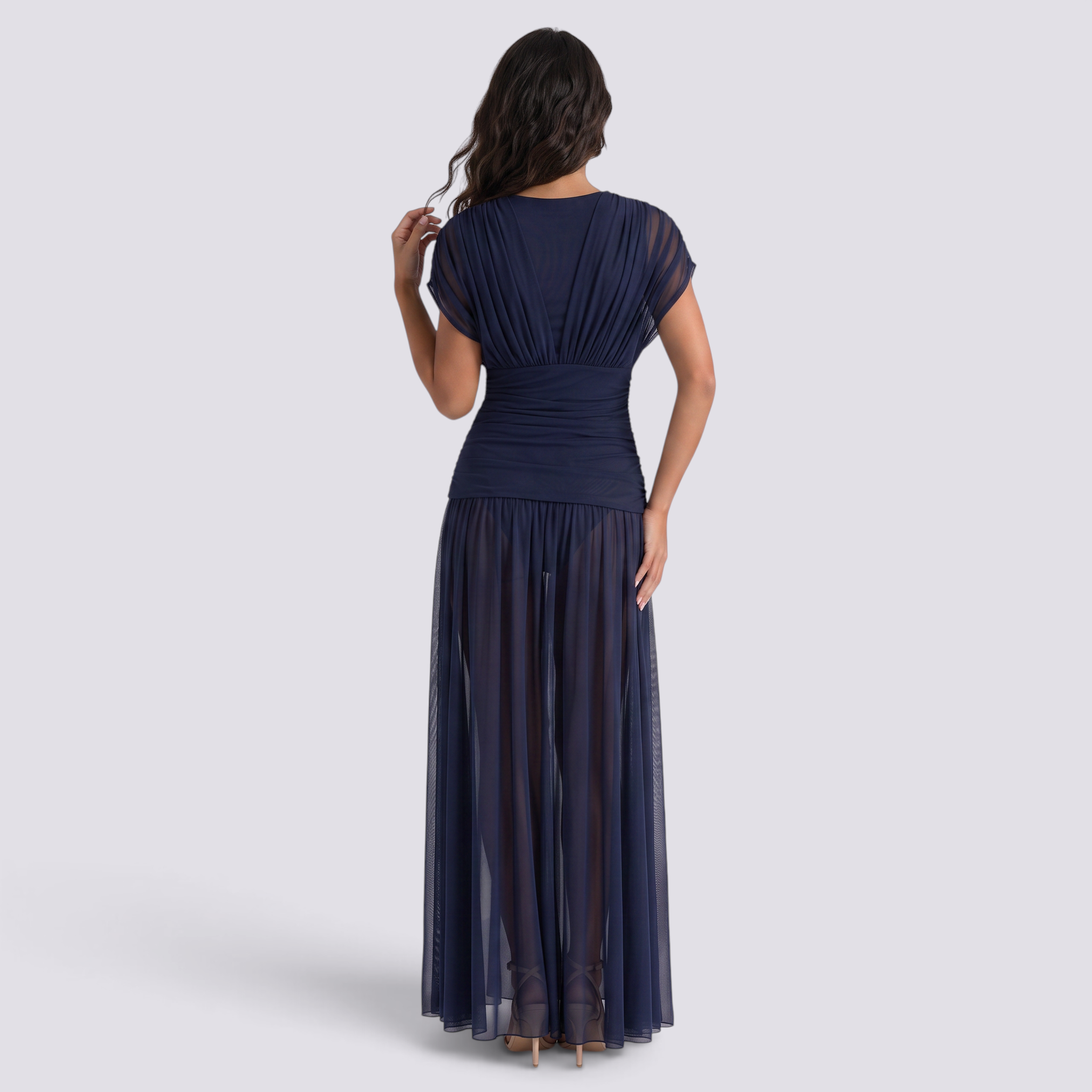 Essyro navy blue floor-length dress with a sheer draped bodice and flowing skirt, viewed from the back.