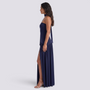 Essyro navy blue floor-length halter neck evening dress with an asymmetric draped skirt and side slit on a model.