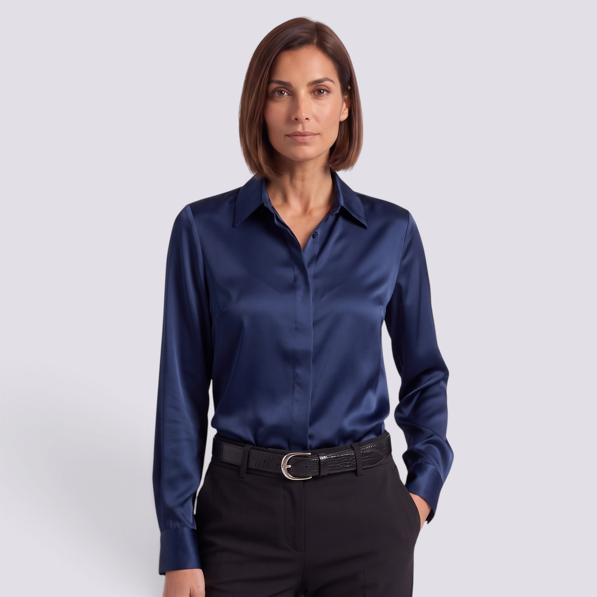 Essyro navy blue satin long-sleeve button-down shirt worn by a woman with black trousers and a leather belt