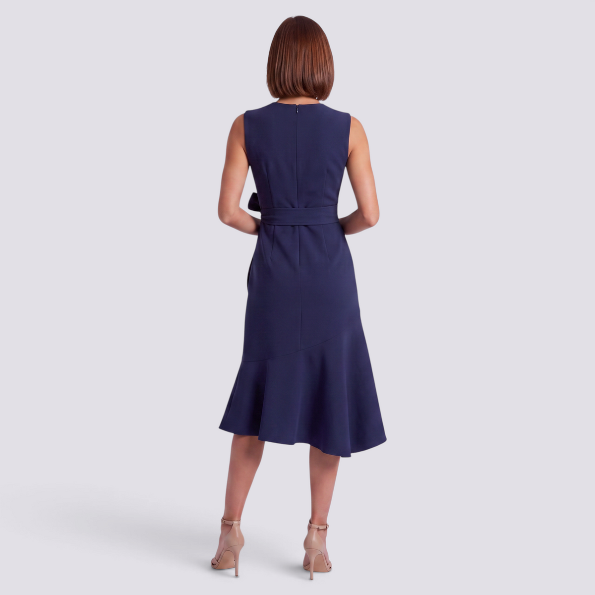 Essyro navy blue sleeveless midi dress with a round neckline and waist bow detail, back view on a model.