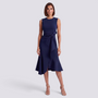 Essyro navy blue sleeveless midi dress with a round neckline and waist bow detail worn by a woman