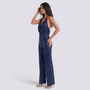 Essyro navy blue sequin halter neck jumpsuit with wide legs and open back worn by a model on a white background