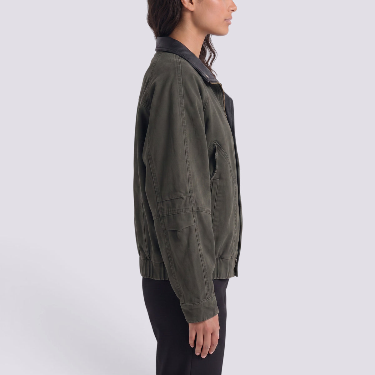 Essyro women's olive green bicolor jacket with a black faux leather collar, side view on a model.