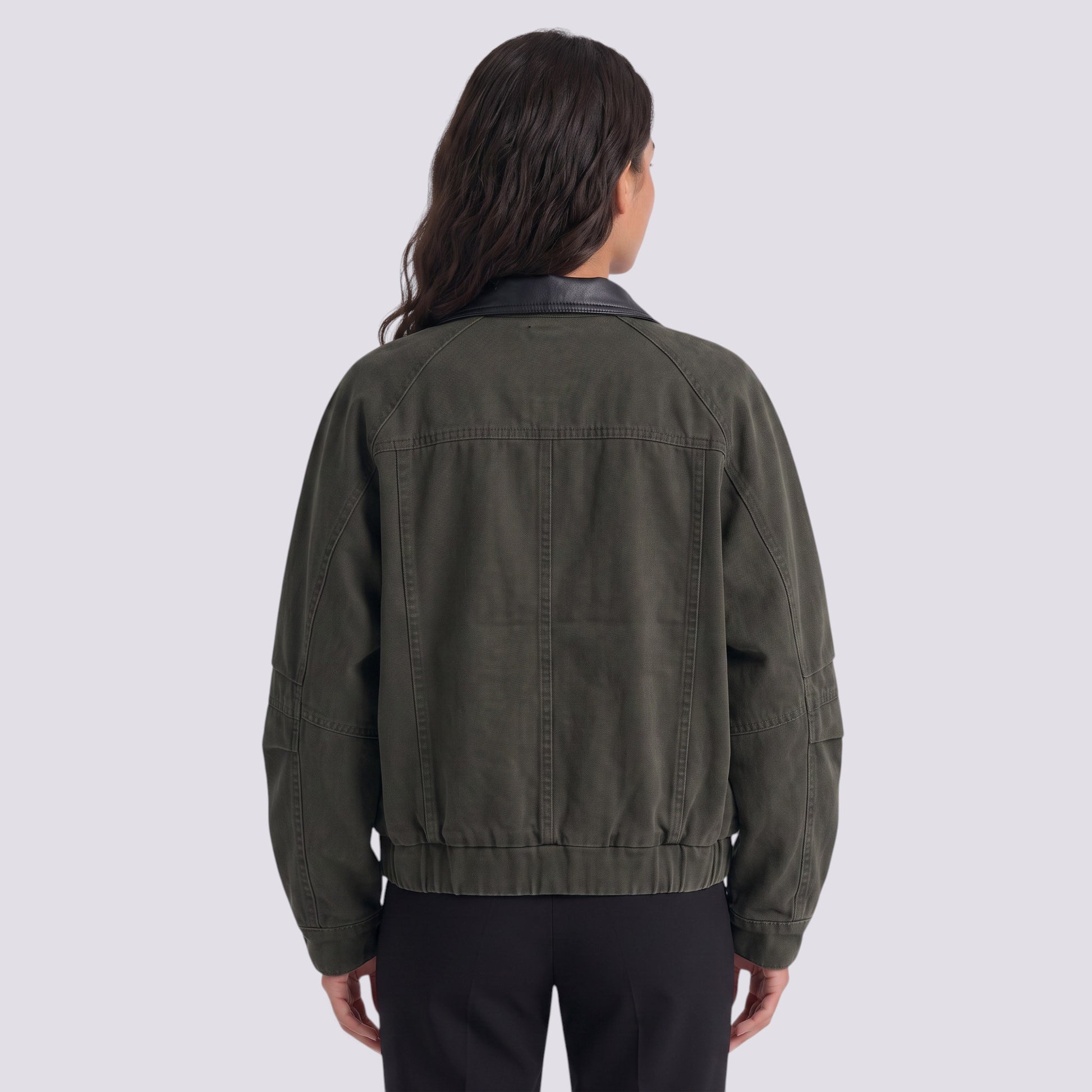 Back view of a woman wearing an Essyro olive green bicolor jacket with a black faux leather collar