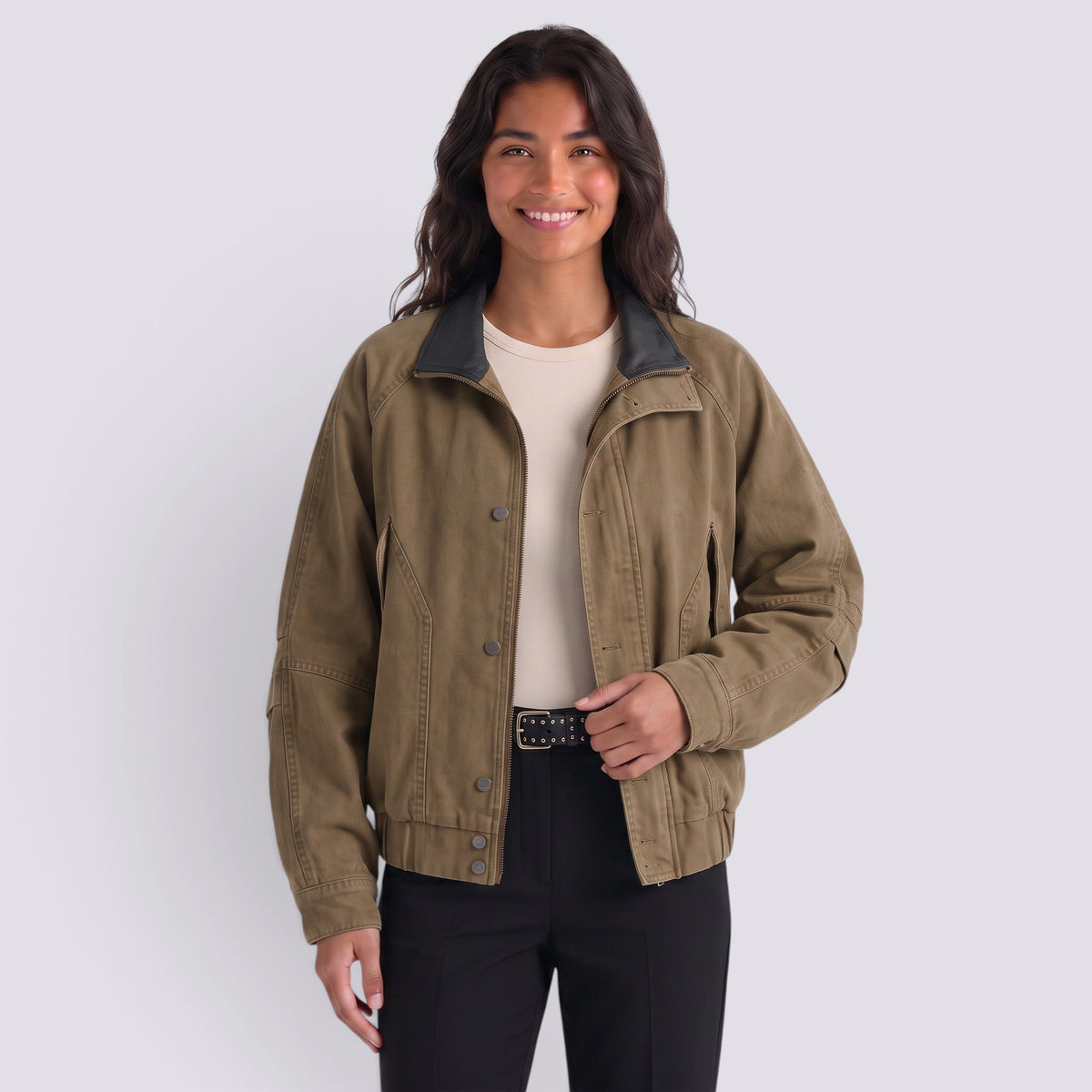 Essyro woman wearing a structured olive green bicolor jacket with a black faux leather collar and front snap closure.