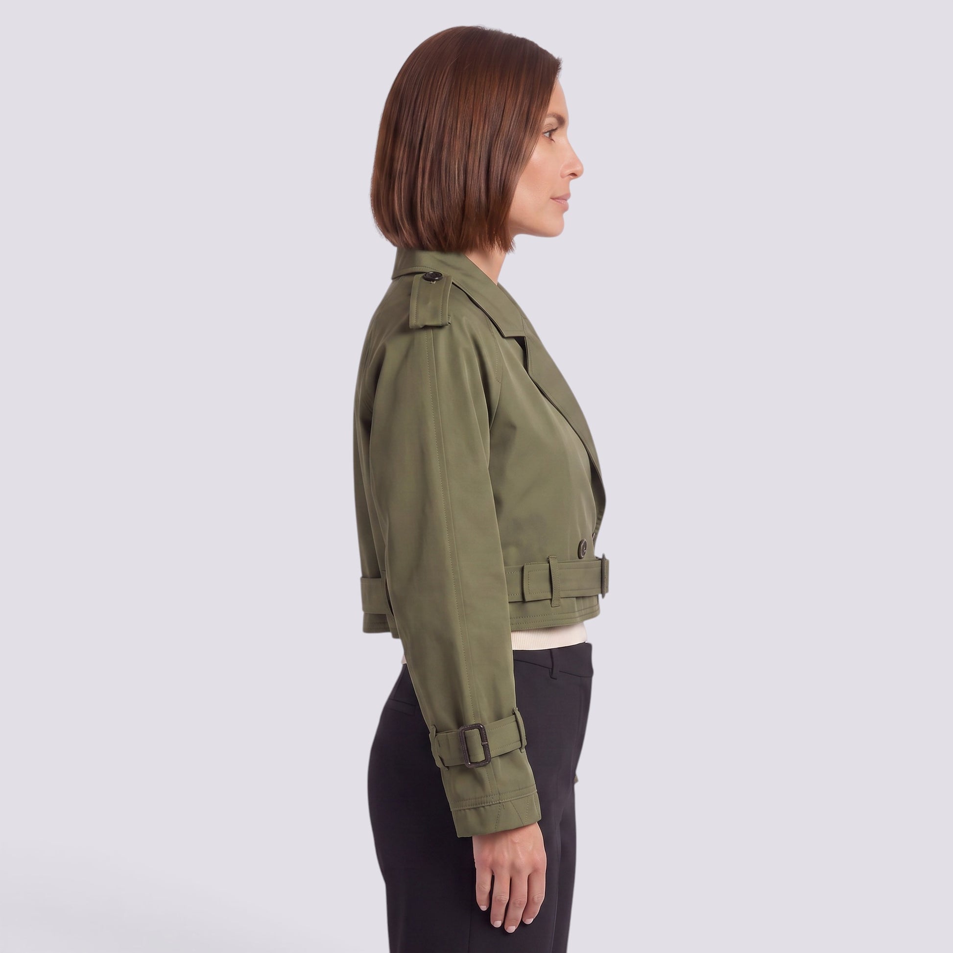 Essyro women's olive green cropped windbreaker jacket with epaulettes and belted cuffs worn by a model side view
