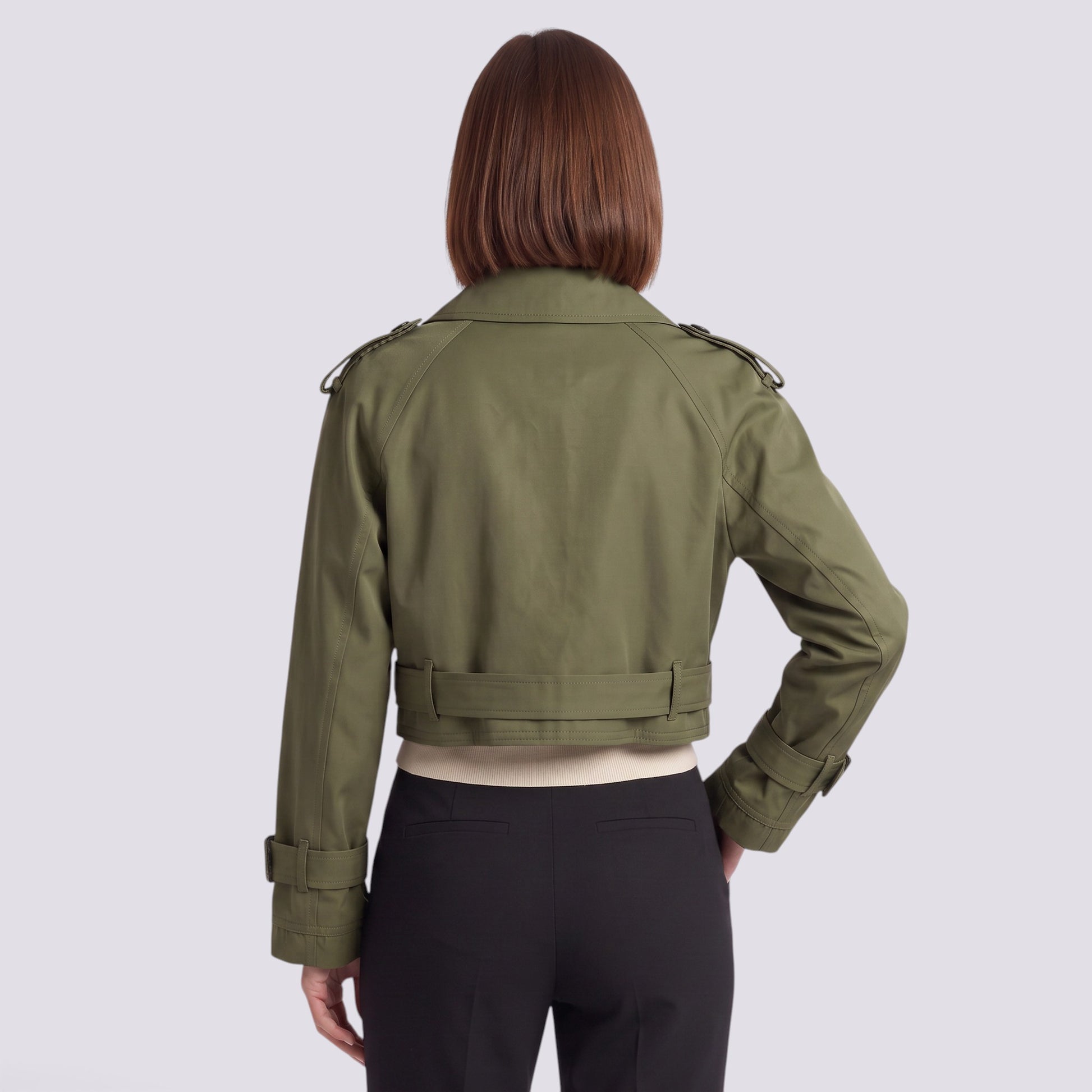 Back view of an Essyro olive green cropped windbreaker jacket with epaulettes and belted cuffs on a woman