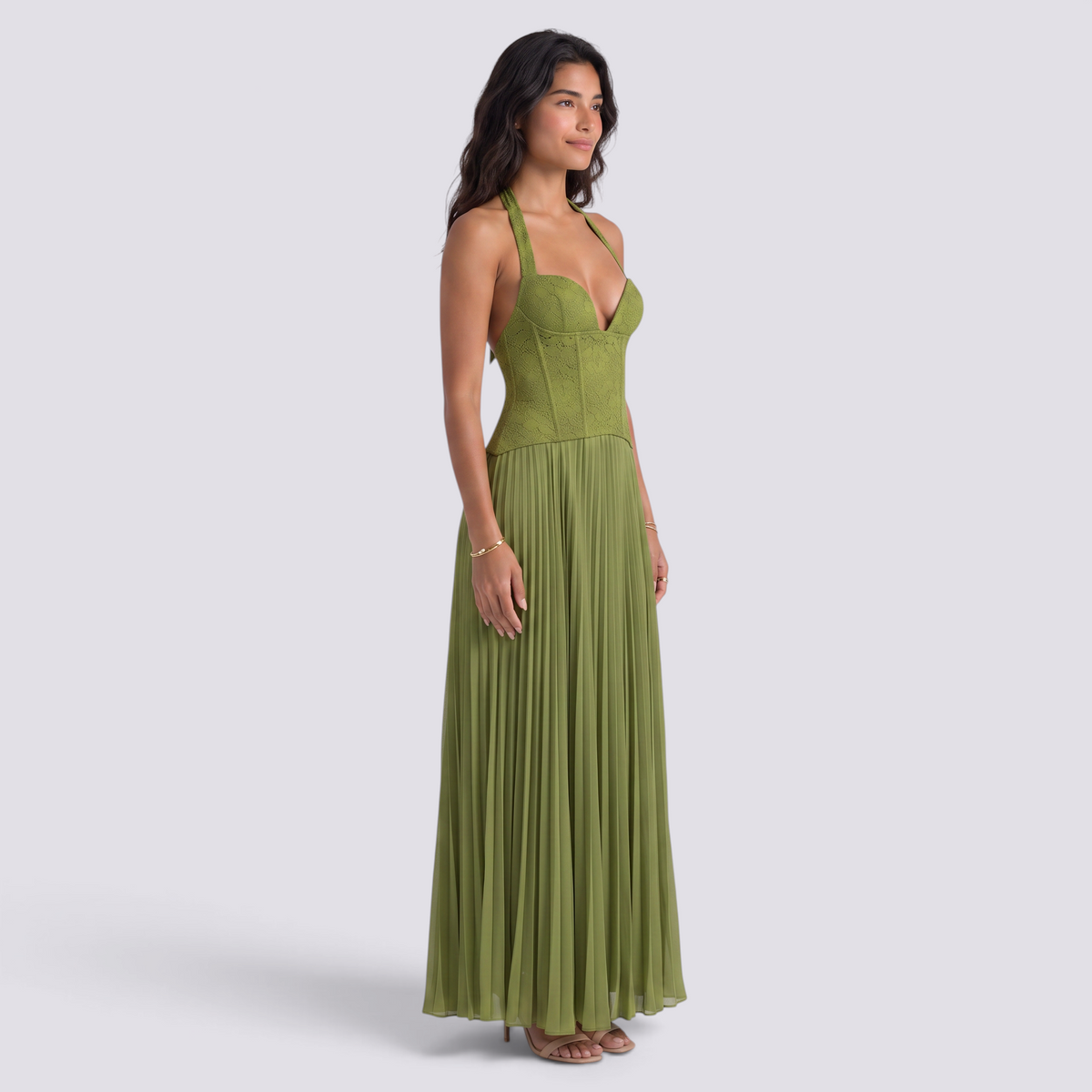 Essyro olive green floor-length halter gown with a corset-style bodice and a flowing pleated skirt on a model