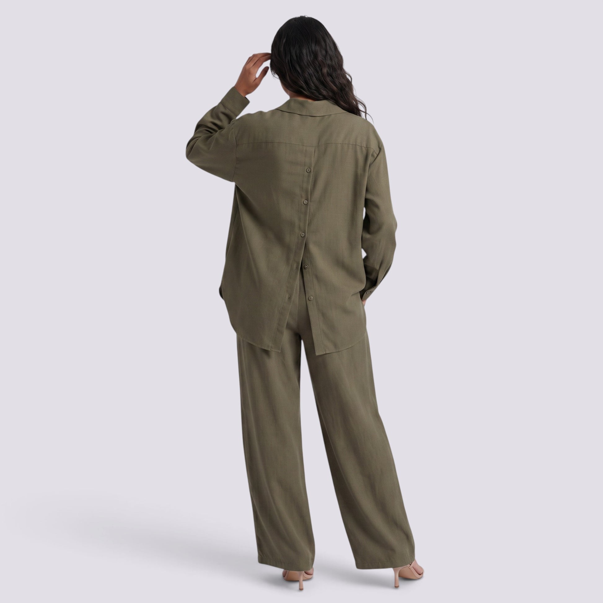 Essyro olive green two-piece set featuring a button-back long-sleeve shirt and wide-leg trousers on a model