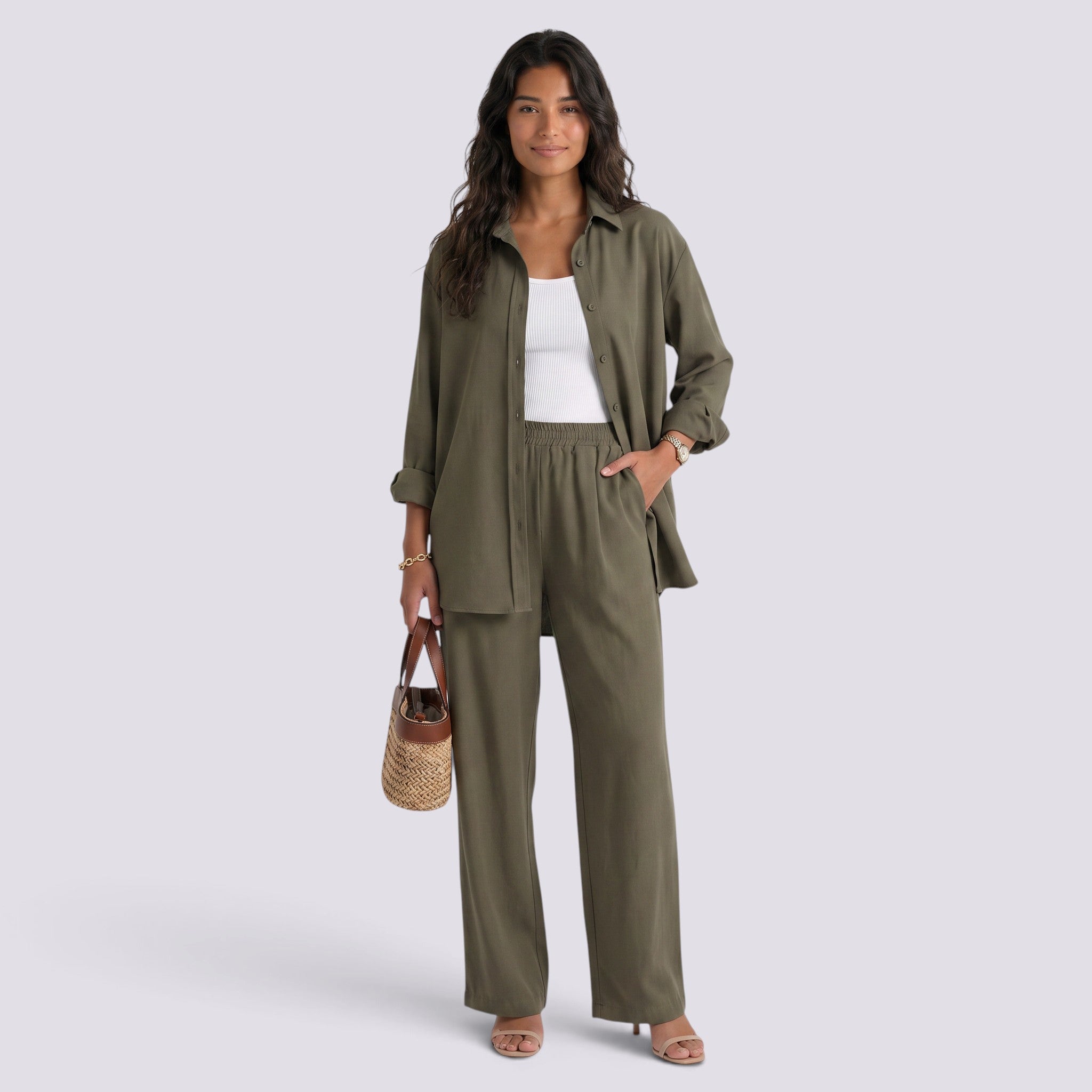 Essyro olive green two-piece set featuring a loose long-sleeve shirt and wide-leg trousers on a woman