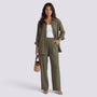 Essyro olive green two-piece set featuring a loose long-sleeve shirt and wide-leg trousers on a woman